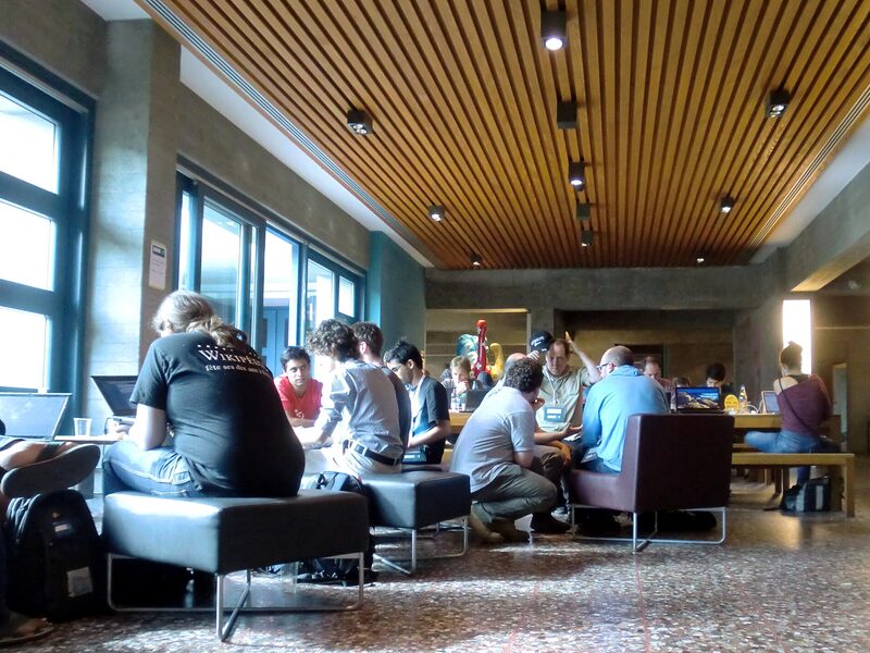 A hackathon room in Zurich, laptops and couches